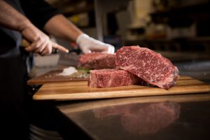 Prime Steak being cut to size